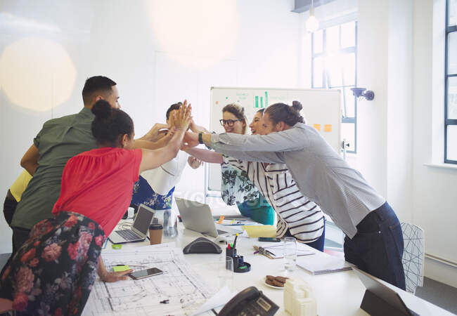 Enthusiastic architects high-fiving in conference room meeting — Stock Photo