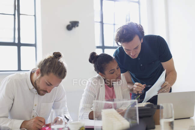 Architects discussing paperwork in conference room meeting — Stock Photo