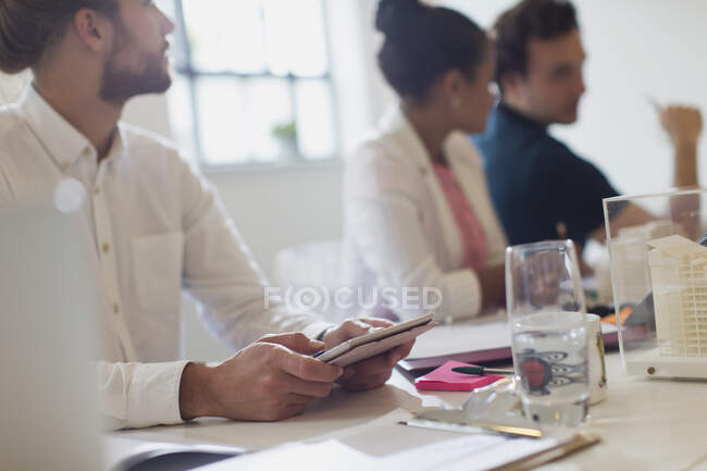 Architect with digital tablet listening in conference room meeting — Stock Photo