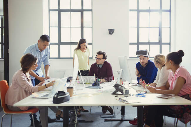 Computer programmers and designers working in open plan office — Stock Photo