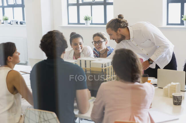 Architects examining model in conference room meeting — Stock Photo