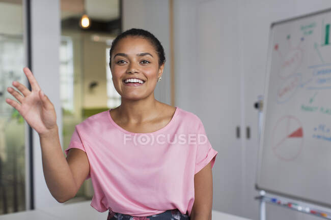Portrait smiling, gesturing businesswoman in office — Stock Photo