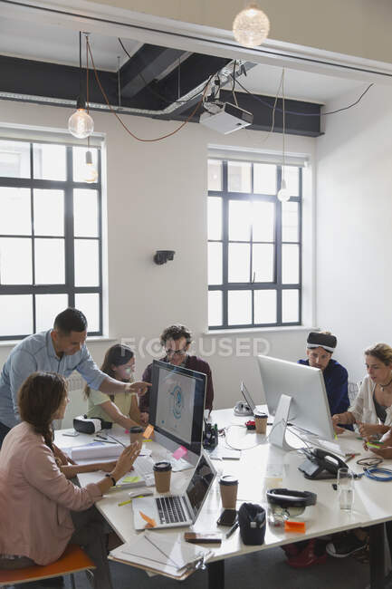 Computer programmers programming virtual reality simulator glasses in open plan office — Stock Photo