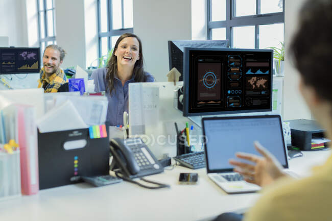 Laughing business people talking in office — Stock Photo