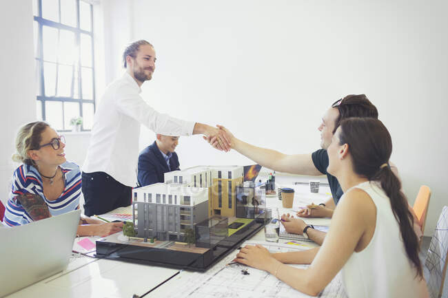 Architects handshaking in conference room meeting — Stock Photo