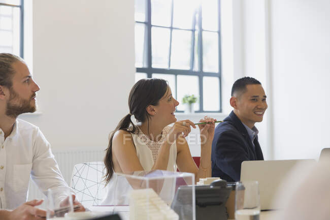 Female architect listening in conference room meeting — Stock Photo