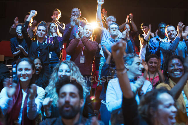Smiling, excited audience cheering — Stock Photo