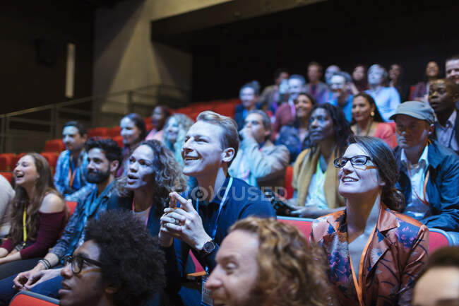 Smiling, attentive man in audience — Stock Photo