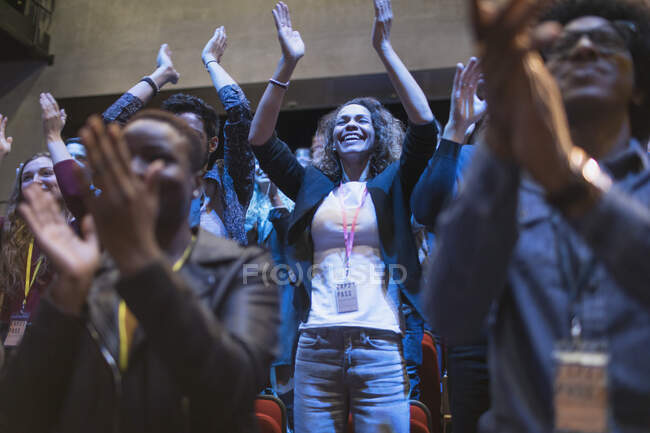 Smiling, enthusiastic woman cheering in audience — Stock Photo