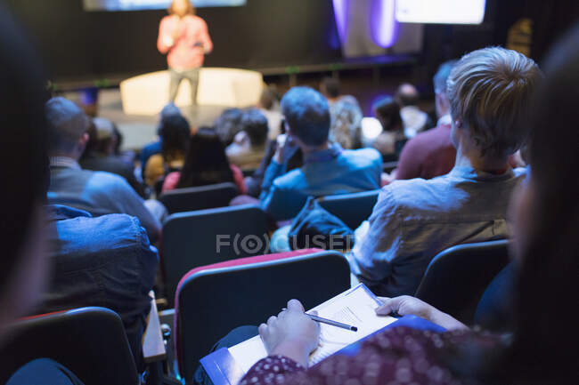 Audience watching speaker on stage — Stock Photo