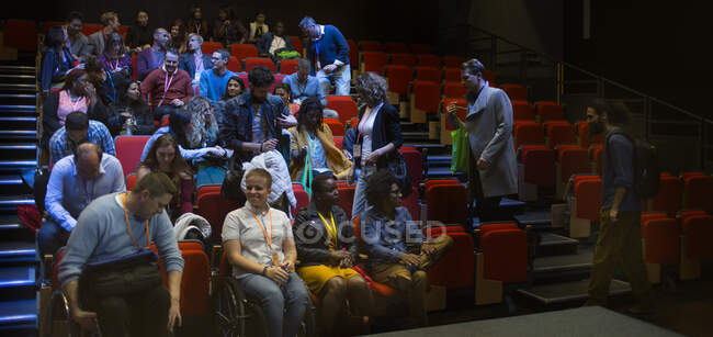 Audience arriving in auditorium — Stock Photo