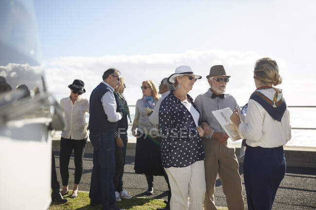 Екскурсовод розмовляє з активними старшими туристами — стокове фото
