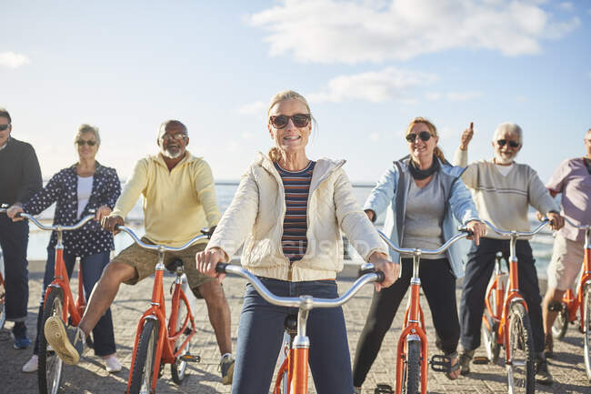 Portrait smiling, confident active senior friend tourists bike riding — Stock Photo