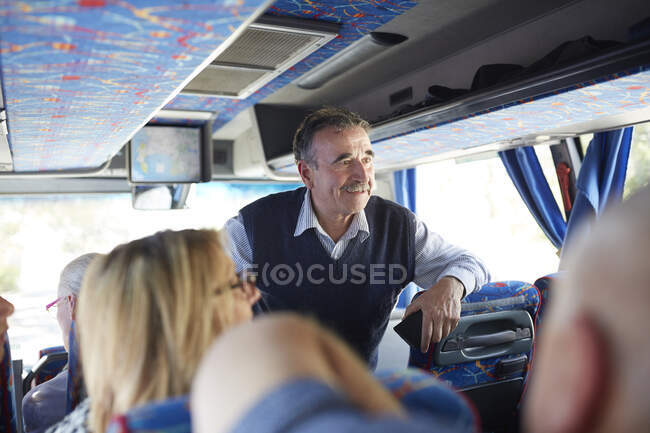 Smiling active senior man tourist on tour bus — Stock Photo