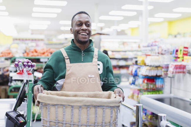 Portrait smiling, confident male grocer working in supermarket — Stock Photo