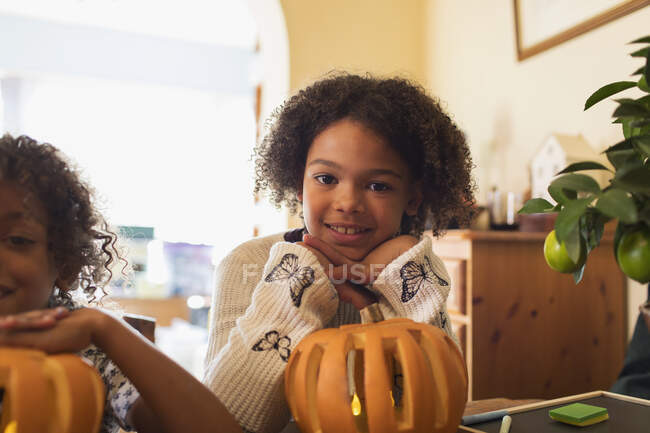 Portrait smiling girl carving pumpkin — Stock Photo