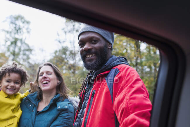 Portrait happy multiethnic family outside car — Stock Photo