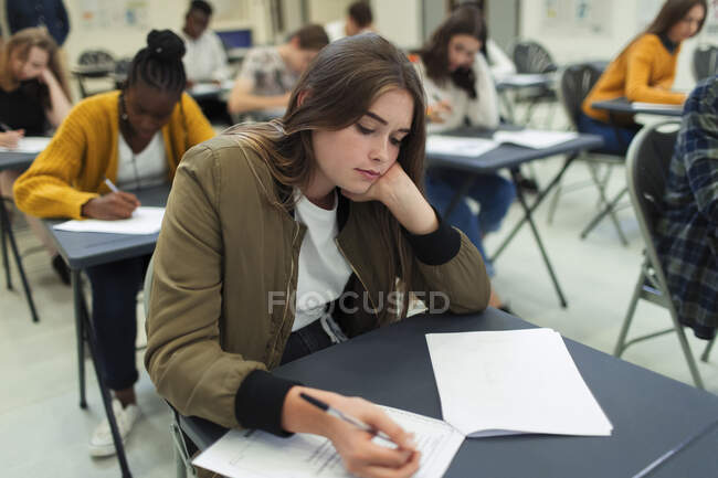 Close up focused high school girl student looking down — Stock Photo