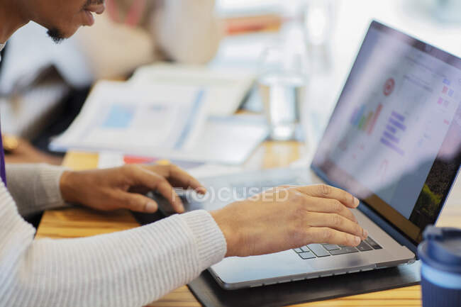 Close up businessman using laptop in meeting — Stock Photo