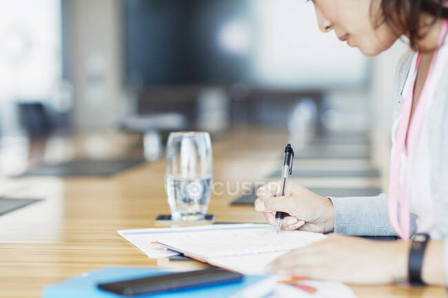 Dedicated businesswoman with paperwork in conference room — Stock Photo