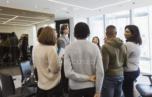 Business people talking in circle in conference room meeting — Stock Photo