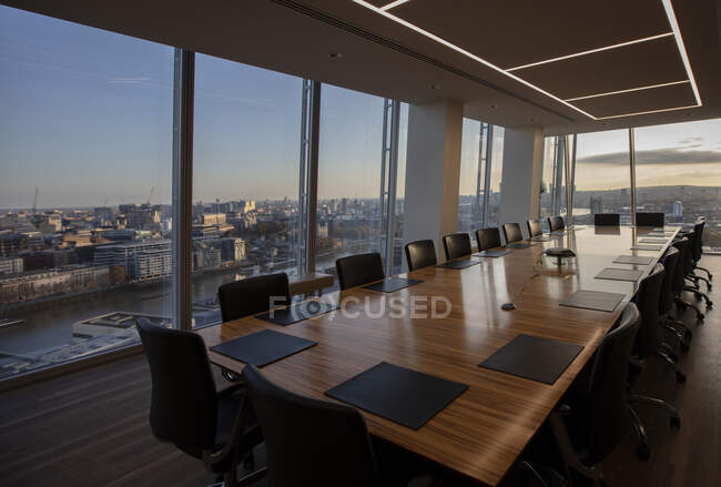 Modern highrise conference room table overlooking city — Stock Photo