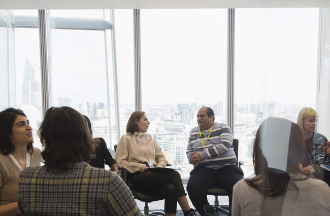 Business people talking in circle in conference room meeting — Stock Photo