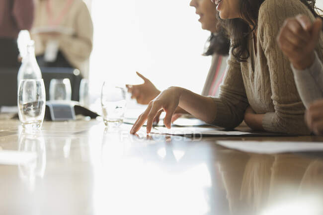 Empresários com papelada na sala de reuniões ensolarada — Fotografia de Stock