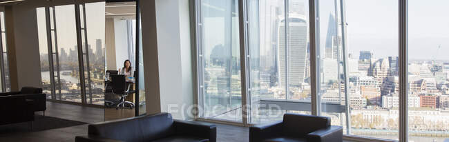 Businesswoman in modern urban highrise conference room — Stock Photo