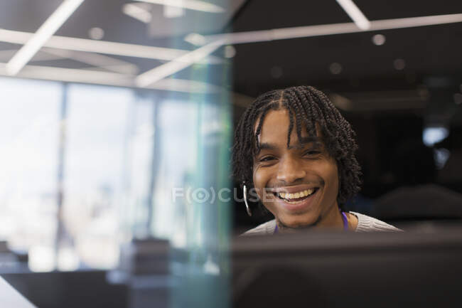 Портрет улыбающийся бизнесмен с наушниками за компьютером — стоковое фото
