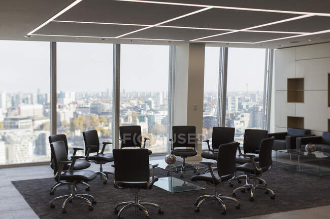 Chairs in circle in modern urban highrise office — Stock Photo