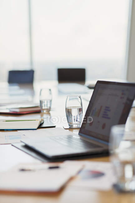 Laptop and paperwork on conference room table — Stock Photo