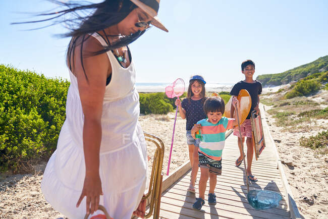 Happy family on sunny beach boardwalk — Stock Photo