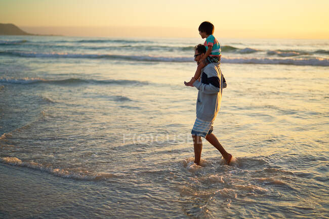 Счастливая семья на солнечном пляже — стоковое фото