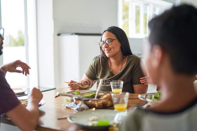 Happy family eating dinner at table — Stock Photo