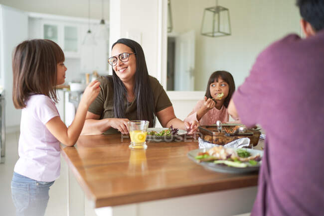 Happy family eating lunch at table — Stock Photo