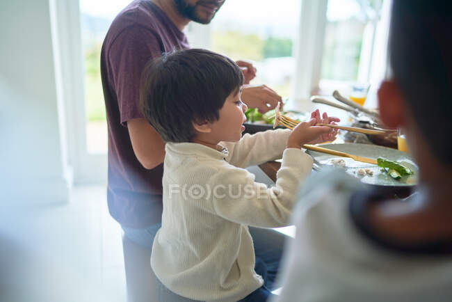 Family eating lunch at table — Stock Photo