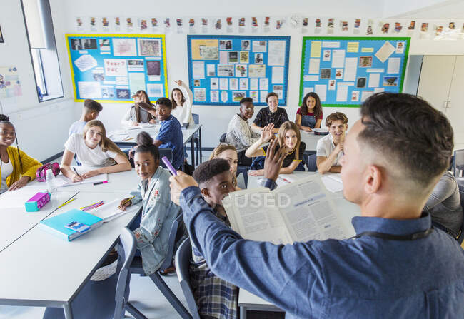 High school teacher calling on students during lesson in classroom — Stock Photo