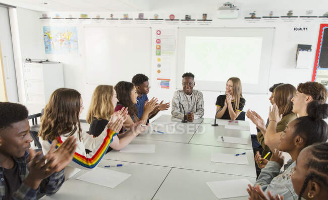High school students clapping in debate class — Stock Photo