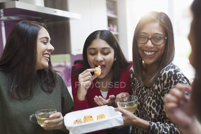Happy family eating and drinking — Stock Photo