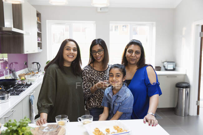 Portrait happy Indian women cooking in kitchen — Stock Photo
