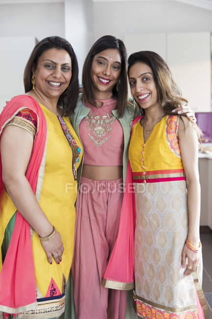 Portrait happy Indian sisters in saris — Stock Photo