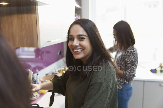 Happy woman cooking in kitchen — Stock Photo