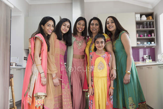 Portrait happy Indian women and girls in saris in kitchen — Stock Photo