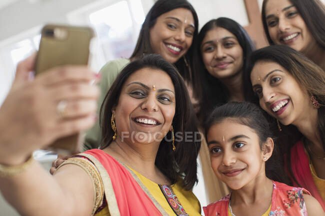 Happy Indian women and girls in bindis taking selfie — Stock Photo