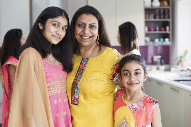 Portrait happy Indian mother and daughters in saris — Stock Photo