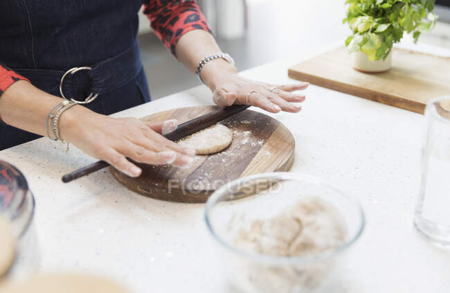 Close up Indian woman making naan  bread in kitchen — Stock Photo