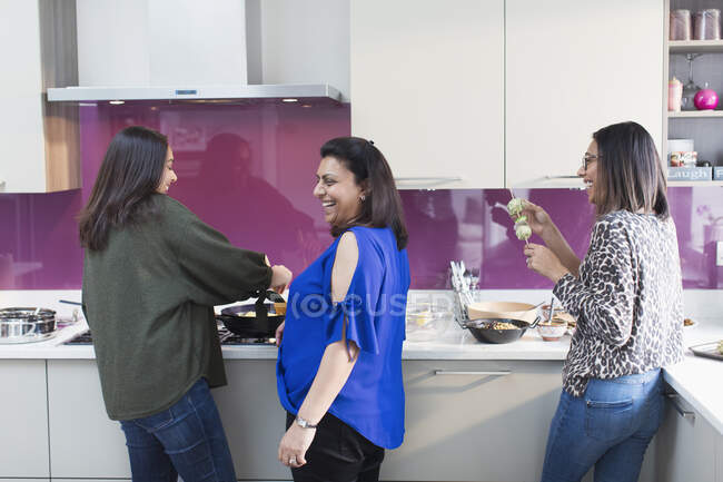 Mulheres indianas felizes cozinhar comida na cozinha — Fotografia de Stock