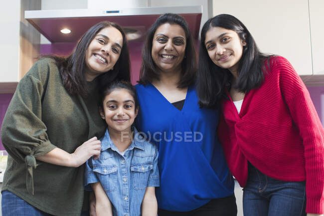 Portrait happy Indian mothers and daughters in kitchen — Stock Photo
