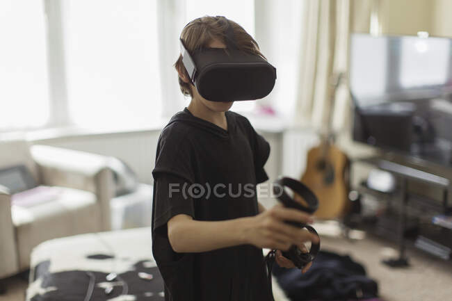 Boy playing video game with VRS goggles — Stock Photo